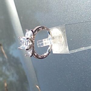 Silver and cubic zirconia three stone engagement ring.